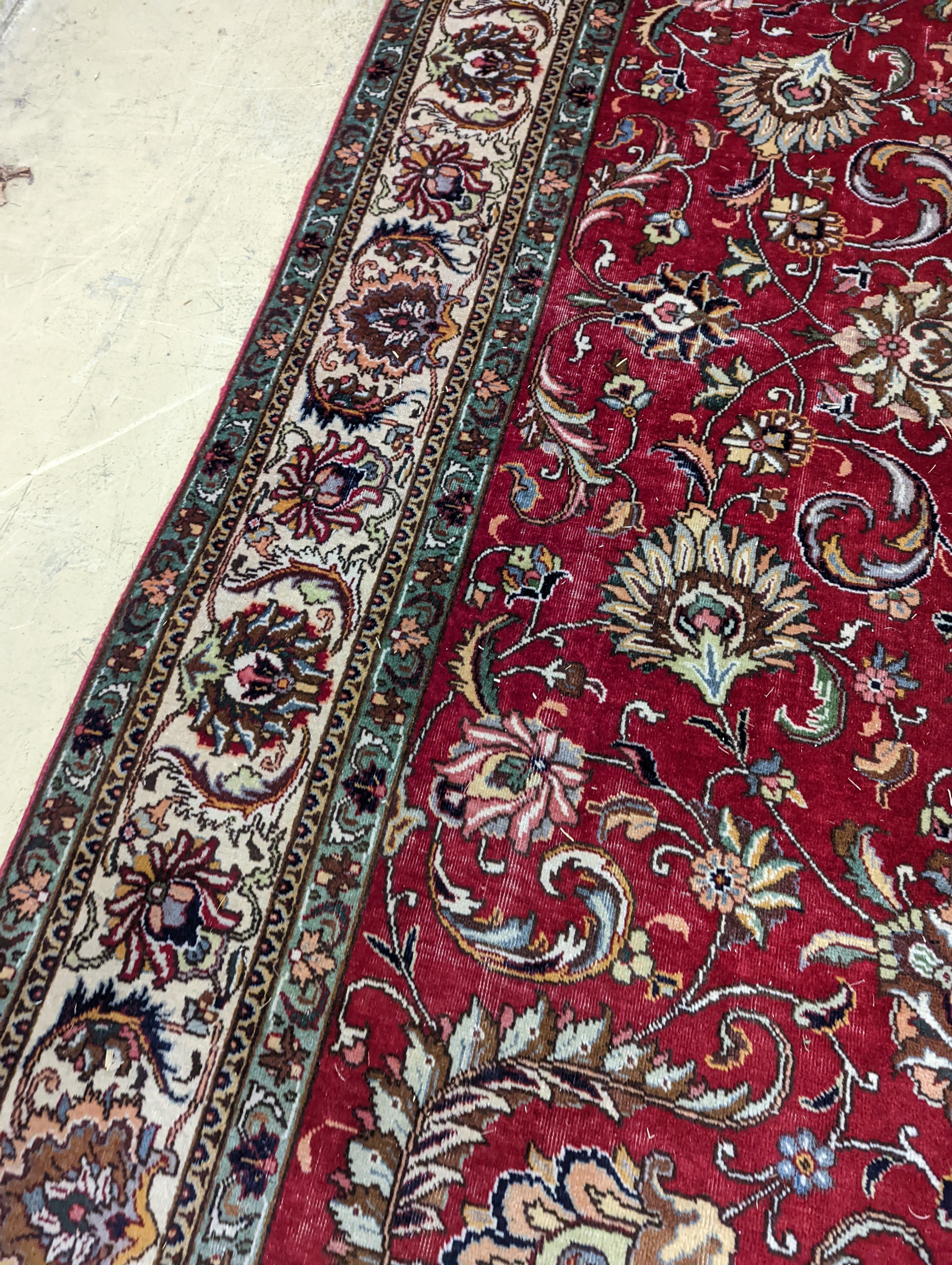 A Tabriz red ground carpet, 400 x 290cm